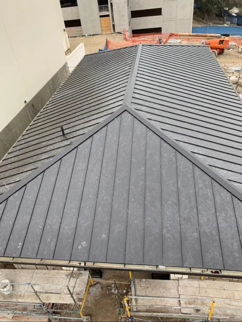 Commercial metal roof construction with crane equipment in Bogalusa