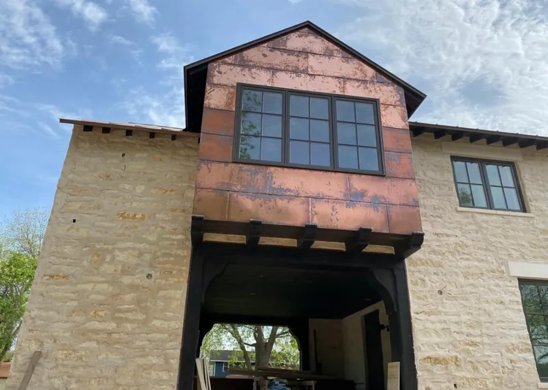 Copper metal panel facade on a stone building for Skylight Installation in Bogalusa