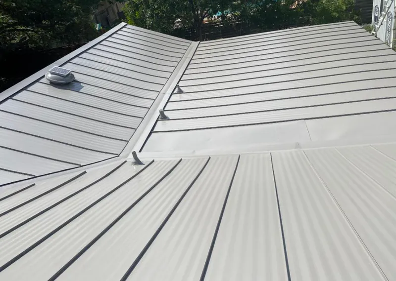 Solar attic fan installed on a metal roof for Roof Ventilation in Bogalusa
